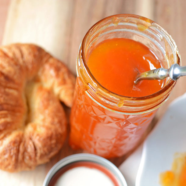 apricot jam in a jar and croissant
