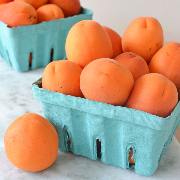 fresh apricots in green boxes