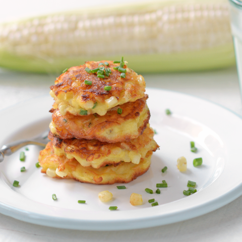 corn fritters with chives on a plate