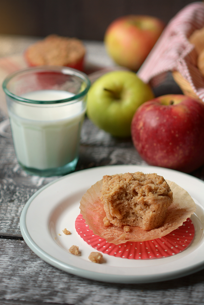 apple cinnamon streusel muffin on a plate with a bite taken out of it