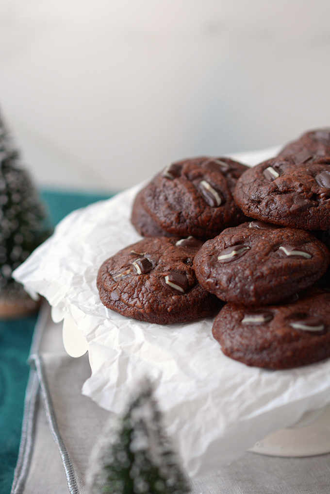 A pile of Triple-Chocolate Andes Mint Cookies on parchment paper.