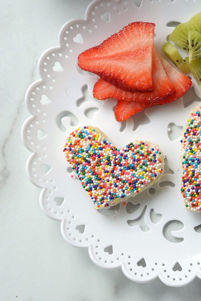 Close-Up Overhead Shot of Heart Shaped Fairy Bread with a Side of Strawberries