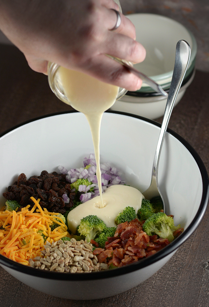 Pouring Homemade Dressing Over Broccoli Salad