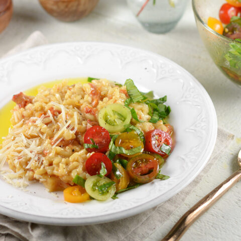 plate of sun dried tomato risotto with tomato basil salad